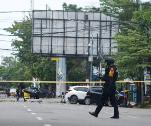 epa09102556 Police counter-terrorism squad members cordon off the area surrounding the Sacred Heart of Jesus Cathedral in the aftermath of an explosion, in Makassar, South Sulawesi, Indonesia, 28 March 2021. At least nine people were wounded as a suspected suicide bomber blew themselves up outside the church on Palm Sunday. The number of casualties was still unclear.  EPA/IQBAL LUBIS