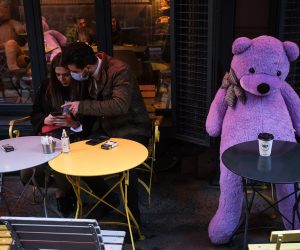 epa09063819 A couple enjoy their time next to a teddy bear at a cafe in Istanbul, Turkey, 09 March 2021. Turkish restaurants and cafes have reopened after three months of closure and many children returned to schools on 09 March after the government announced steps to ease COVID-19 curbs even as cases grow higher, raising concerns in the top medical associations.  EPA/SEDAT SUNA