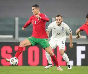 epa09094722 Portugal's Cristiano Ronaldo (L) fights for the ball with Azerbaijan's Elvin Badalov during the FIFA World Cup Qatar 2022 Group A qualifier match Portugal against Azerbaijan in Turin, Italy, 24 March 2021.  EPA/MIGUEL A. LOPES