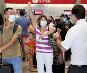 epa09104395 A passenger reacts as she attempts to check in for a flight from the domestic airport in Brisbane, Autralia, 29 March 2021. Greater Brisbane will enter a snap three-day lockdown as its coronavirus outbreak continues to grow.  EPA/DAVE HUNT AUSTRALIA AND NEW ZEALAND OUT