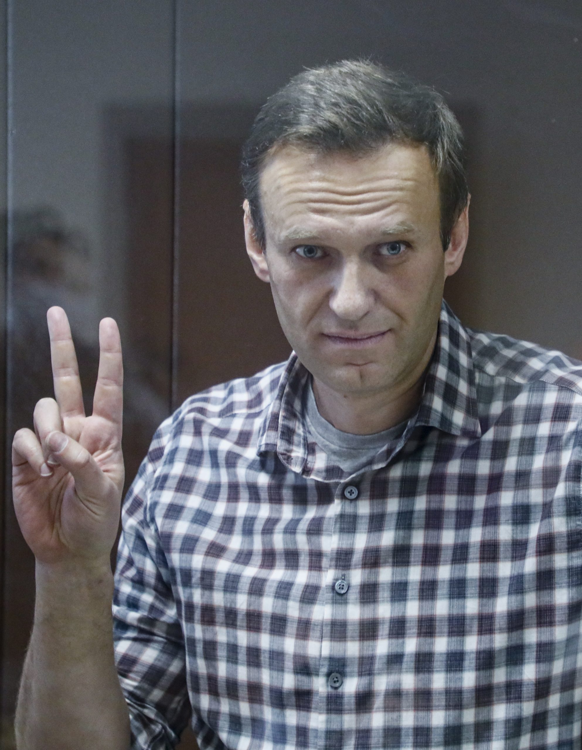 epa09108967 (FILE) Russian opposition leader Alexei Navalny gestures inside a glass cage prior to a hearing at the Babushkinsky District Court in Moscow, Russia, 20 February 2021 (reissued 31 March 2021). Russian opposition leader Alexei Navalny, who serves his 2,5 years sentence in a prison colony in the town of Pokrov in the Vladimir region, announced he is going on hunger strike in a protest of mistreatment in the prison.  EPA/YURI KOCHETKOV *** Local Caption *** 56711412