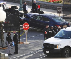 epa09112604 Officials tow the vehicle from the scene after it rammed a barricade outside the US Capitol in Washington, DC, USA, 02 April 2021. According to US Capitol Police one police officer was killed and another injured after a vehicle rammed into the North Barricade at the US Capitol. A man was shot after exiting the vehicle wielding a knife, he later succumbed to his injuries.  EPA/SHAWN THEW
