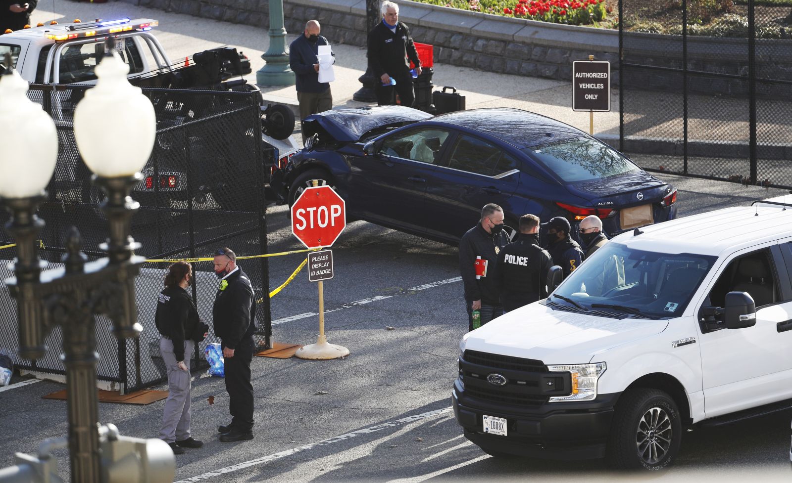 epa09112604 Officials tow the vehicle from the scene after it rammed a barricade outside the US Capitol in Washington, DC, USA, 02 April 2021. According to US Capitol Police one police officer was killed and another injured after a vehicle rammed into the North Barricade at the US Capitol. A man was shot after exiting the vehicle wielding a knife, he later succumbed to his injuries.  EPA/SHAWN THEW
