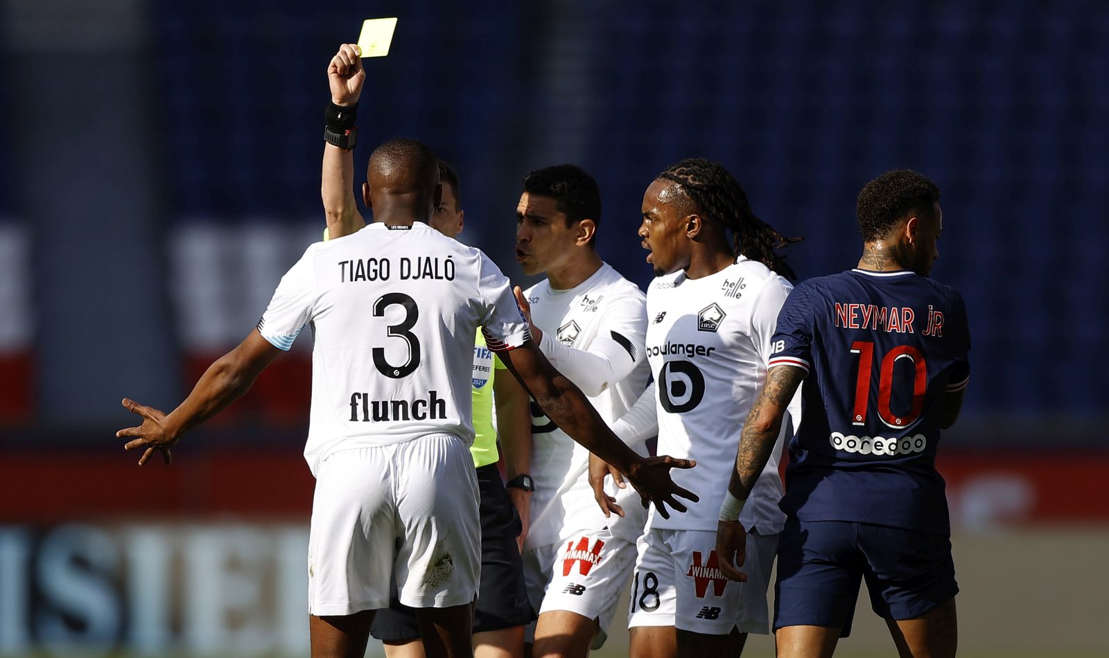 epa09113653 Tiago Djalo of Lille OSC is booked during the French Ligue 1 soccer match between Paris Saint German and Lille OSC, in Paris, France, 03 April 2021.  EPA/IAN LANGSDON