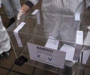 epa09114919 A staff member of a mobile polling station wearing a protective suits holds a mobile ballot box at Pirogov Hospital in Sofia, Bulgaria, 04 April 2021. Bulgaria is holding a parliamentary election on 04 April amid a surge in coronavirus COVID-19 cases. Despite criticisms, the GERB party led by incumbent Prime Minister Boyko Borissov is leading the polls and is expected to win another four-year term.  EPA/VASSIL DONEV
