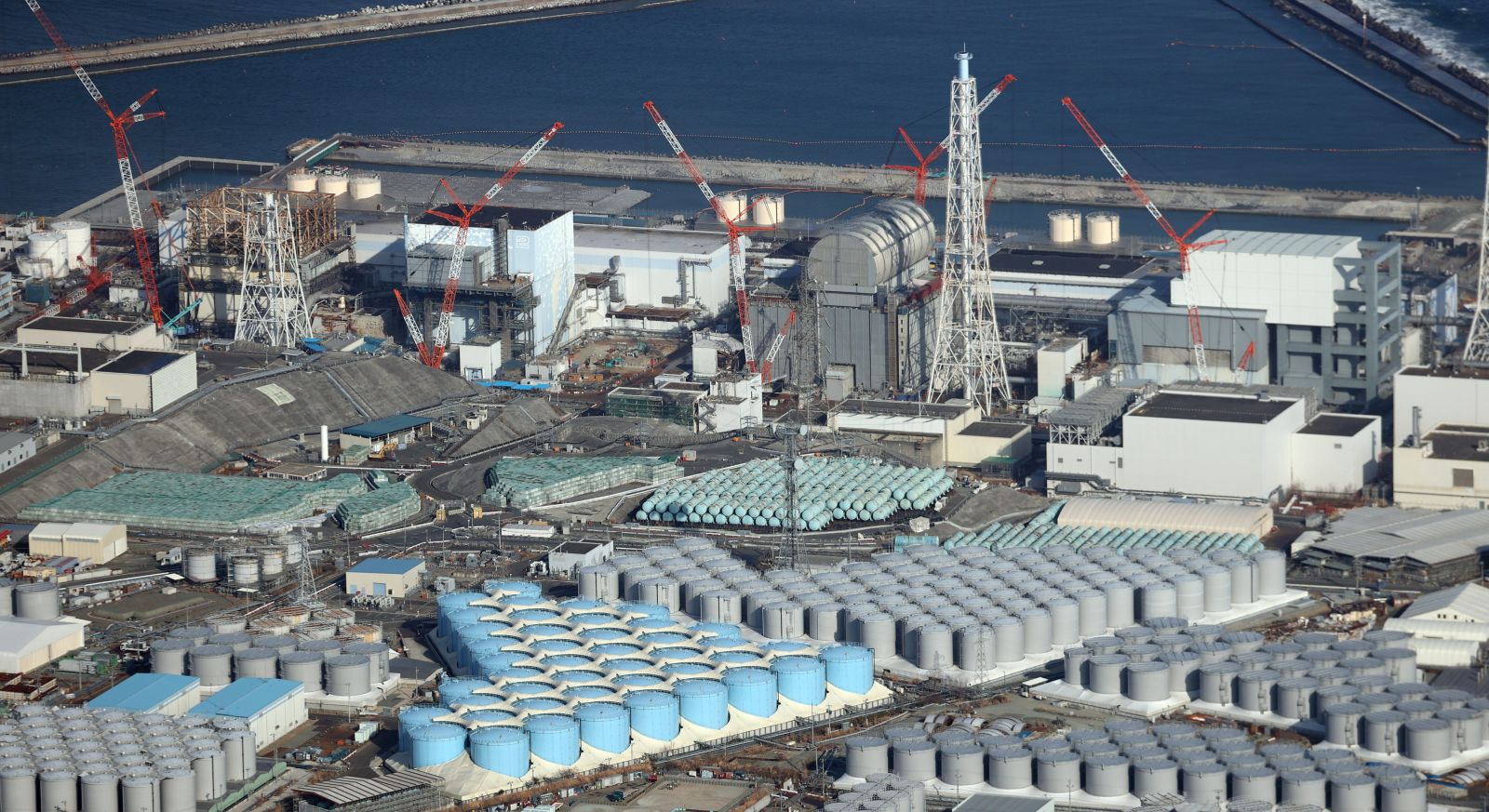 epa09131838 An aerial view shows tanks containing contaminated water at the Fukushima Daiichi nuclear power plant, which suffered meltdowns on 11 March 2011, in Fukushima prefecture, northeastern Japan, 14 February 2021 (reissued 13 April 2021). On 13 April 2021, the Japanese government officially decided to release treated water containing tritium from the crippled Fukushima Daiichi Nuclear Power Plant into the ocean.  EPA/JIJI PRESS JAPAN OUT EDITORIAL USE ONLY/  NO ARCHIVES