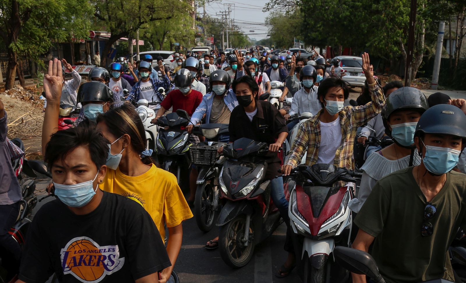 epa09134199 Demonstrators on motorcycles flash the three-finger salute during an anti-military coup protest in Mandalay, Myanmar, 14 April 2021. According to the Assistance Association for Political Prisoners (AAPP), at least 700 people have been killed by Myanmar armed forces since the military seized power on 01 February 2021. Protests continue despite the intensifying crackdown on demonstrators.  EPA/STRINGER