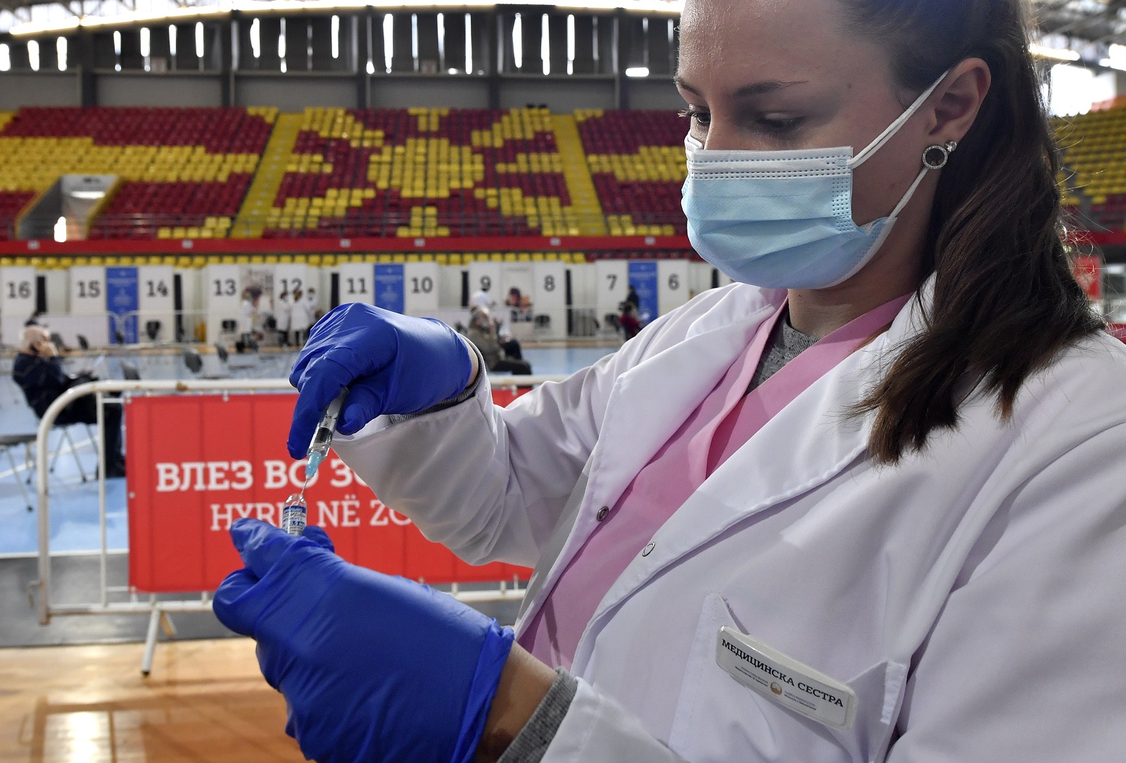 epa09136824 A nurse prepares the Russian Sputnik V vaccine against coronavirus disease (COVID-19) during vaccination at the Arena 'Boris Trajkovski' in Skopje, Republic of North Macedonia, 15 April 2021. North Macedonia continue COVID-19 vaccination campaign of elderly people with Russian Sputnik V vaccine. The numbers of newly infected and deaths from coronavirus remains high despite strict government measures to prevent the spread of pandemic. Vaccination is ongoing but North Macedonia is still unable to provide sufficient numbers of vaccines for mass vaccination.  EPA/GEORGI LICOVSKI