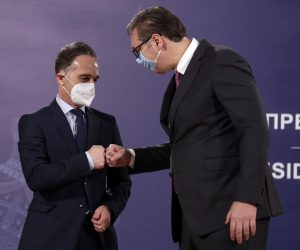 epa09154392 Serbian President Aleksandar Vucic (R) and German Foreign Minister Heiko Maas (L) fist bump after their meeting in Belgrade, Serbia, 23 April 2021. Foreign Minister Maas is on an official visit to Serbia.  EPA/ANDREJ CUKIC