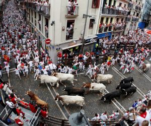 epa09161468 (FILE) - Runners triy to avoid bulls as they run down a street during the traditional San Fermin bull run in Pamplona, Spain, 07 July 2019 (reissued 26 April 2021). According to the mayor of Pamplona, the Sanfermines 2020 festival was canceled due to the coronavirus pandemic for the second consecutive year.  EPA/VILLAR LOPEZ *** Local Caption *** 56037227