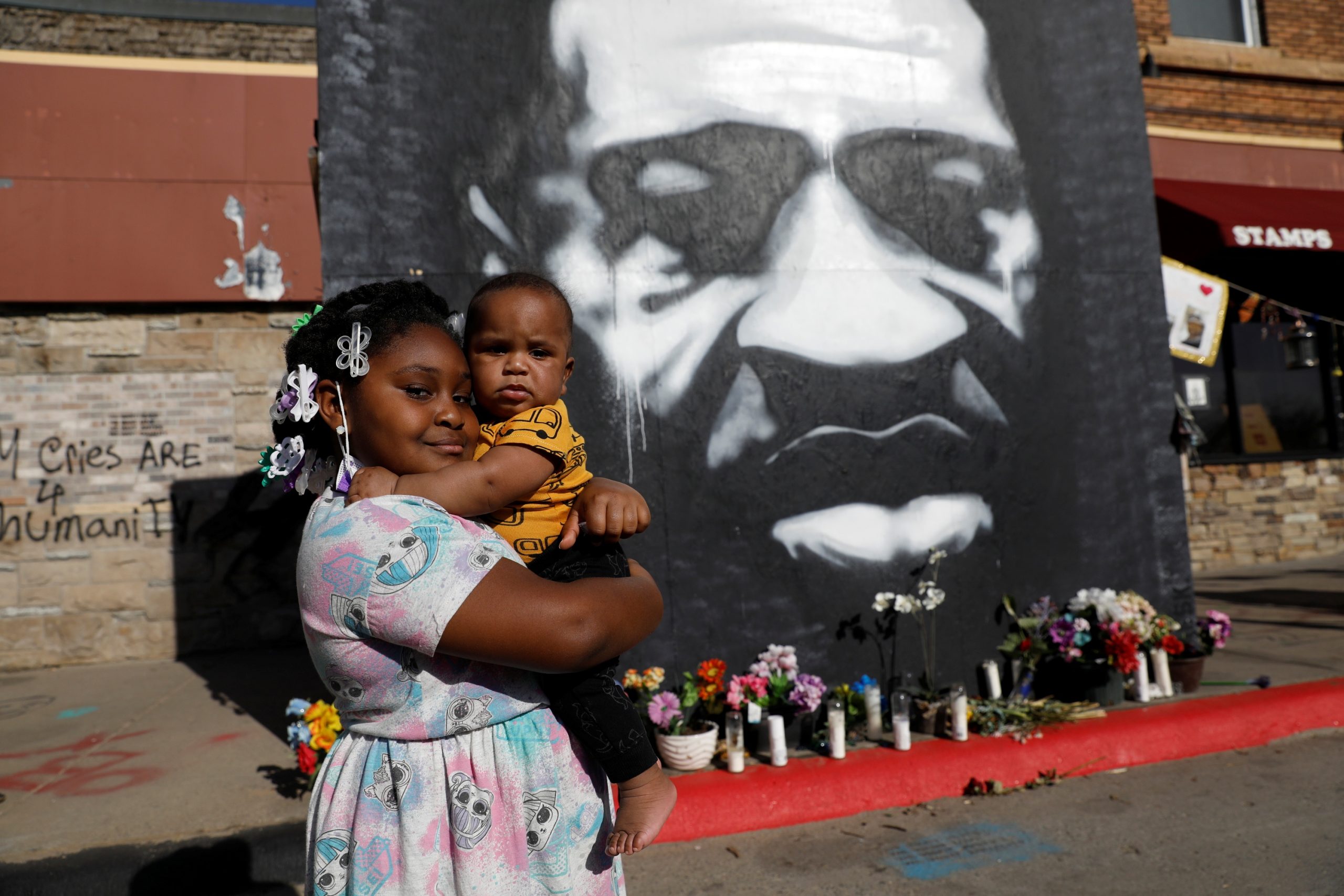Visitors at George Floyd Square in Minneapolis Journey Stephens holds her 6-month-old brother Dreshoan at George Floyd Square, after the first week in the trial of Derek Chauvin, who is facing murder charges in the death of George Floyd, in Minneapolis, Minnesota, U.S., April 3, 2021. REUTERS/Octavio Jones OCTAVIO JONES