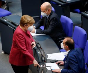 Session of the German Bundestag in Berlin German Chancellor Angela Merkel speaks with parliamentary group leader of the Christian Social Union (CSU) party Alexander Dobrindt during a session of the lower house of parliament Bundestag debating the coronavirus disease (COVID-19) measures, in Berlin, Germany, April 16, 2021. REUTERS/Michele Tantussi MICHELE TANTUSSI