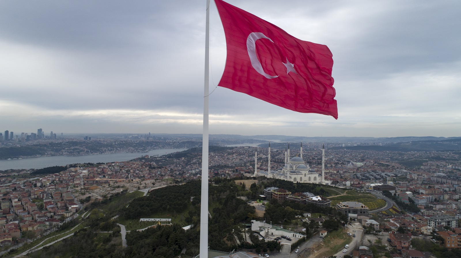 epa09155224 An aerial picture taken with a drone shows a huge Turkish flag fluttering at the Camlica Hill in Istanbul, Turkey, 23 April 2021. A 111-meter-long (364 feet) and 1,000-square-meter (107,639-square-foot) wide Turkey's tallest flag was inaugurated on Istanbul’s Camlıca Hill as Turkish President Recep Tayyip Erdogan attended with a group of children during the occasion of National Sovereignty and Children’s Day.  EPA/ERDEM SAHIN
