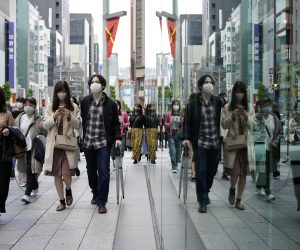 epa09158059 Pedestrians wearing protective face masks walk through Ginza shopping district in Tokyo, Japan, 25 April 2021. People crowded the streets in Ginza, the day the third state of emergency took effect in Tokyo. The country is affected by a surge of COVID-19 cases just three months before from the opening of the Tokyo Olympic Games and the new state of emergency is imposed in Tokyo and major western Japan prefectures from 25 April until 11 May.  EPA/FRANCK ROBICHON