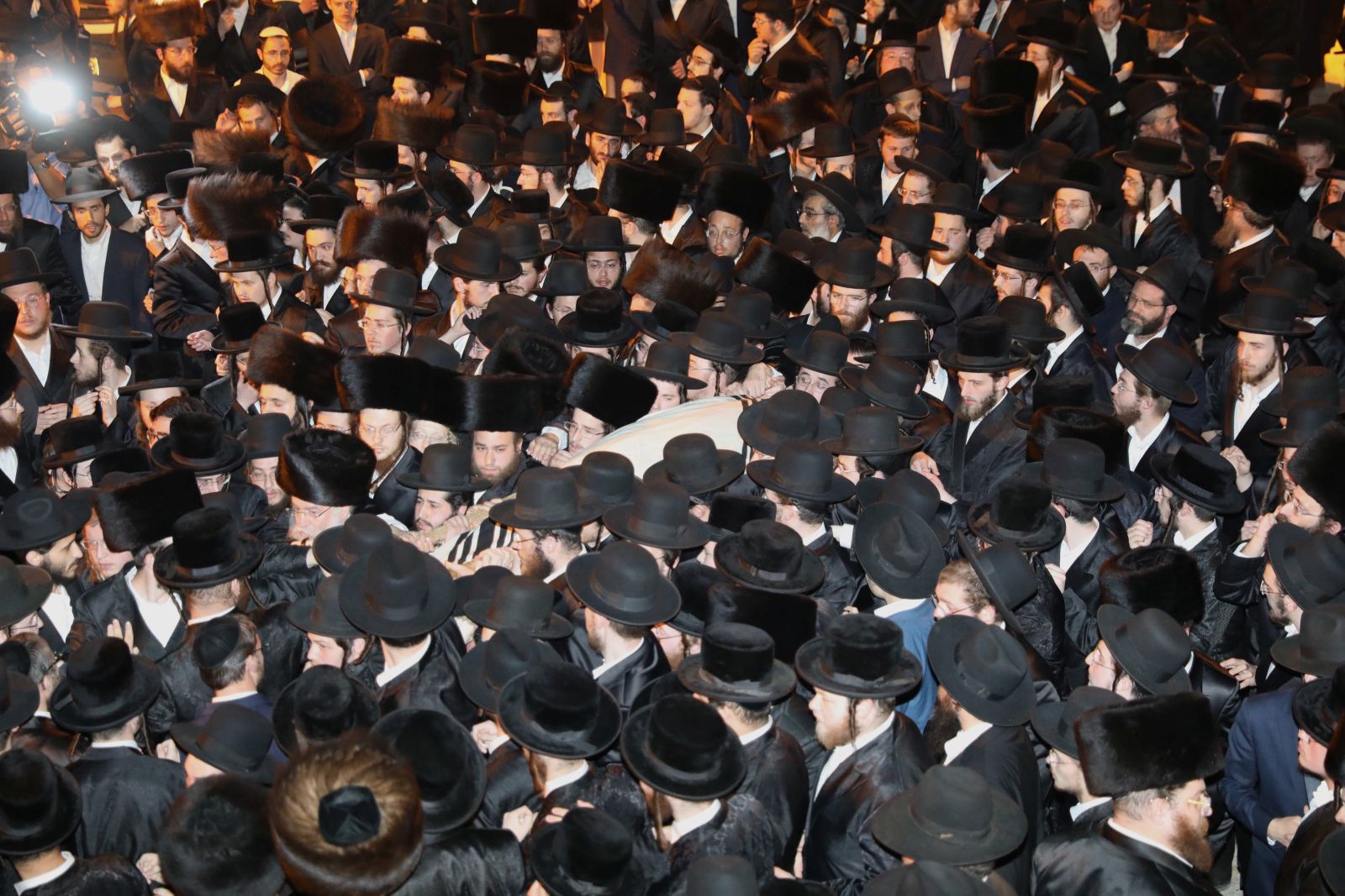 epa09172631 Ultra-Orthodox mourners carry the body of Menachem Kenlowitz who died in a stampede during Lag Ba'Omer in Mount Meron during his funeral at the Shamgar Funeral House in Jerusalem, 01 May 2021.  At least 45 people were killed and scores injured in the revelry complex on Mount Meron, after an apparent stampede occured on early 30 April 2021 during an event marking the end of the Jewish holiday of Lag Ba'Omer, the day that marks the death anniversary of Rabbi Shimon bar Yochai, a sage from some 1,800 years ago, and the day on which he revealed the secrets of the 'kabbalah,' or Jewish mysticism.  EPA/ABIR SULTAN