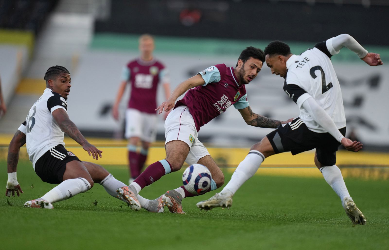 epa09189994 Kenny Tete (R) and Mario Lemina (L) of Fulham in action against Dwight McNeil (C) of Burnley during the English Premier League soccer match between Fulham FC and Burnley FC in London, Britain, 10 May 2021.  EPA/Clive Rose / POOL EDITORIAL USE ONLY. No use with unauthorized audio, video, data, fixture lists, club/league logos or 'live' services. Online in-match use limited to 120 images, no video emulation. No use in betting, games or single club/league/player publications.