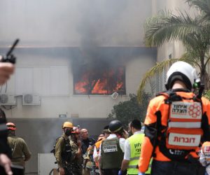 epa09191032 Israeli emergency services on the scene where a rocket fired from the Gaza Strip hit a house in the city of Ashdod, Israel, 11 May 2021. Israel Defense Forces (IDF) said they hit over 100 Hamas targets in the Gaza Strip during a retaliatory overnight strike after rockets were fired at Israel by Palestinian militants.  EPA/ABIR SULTAN