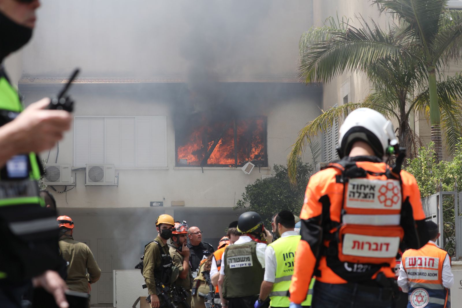 epa09191032 Israeli emergency services on the scene where a rocket fired from the Gaza Strip hit a house in the city of Ashdod, Israel, 11 May 2021. Israel Defense Forces (IDF) said they hit over 100 Hamas targets in the Gaza Strip during a retaliatory overnight strike after rockets were fired at Israel by Palestinian militants.  EPA/ABIR SULTAN
