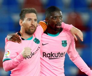 epa09192443 FC Barcelona's Lionel Messi (L) celebrates with teammate Ousmane Dembele after scoring the 0-1 during the Spanish LaLiga soccer match between Levante UD and FC Barcelona at Ciutat de Valencia stadium in Valencia, eastern Spain, 11 May 2021.  EPA/Juan Carlos Cardenas