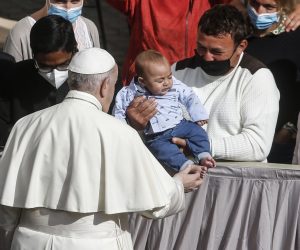 epa09193142 Pope Francis hugs a child during the general audience with the public after the restrictions due to the coronavirus pandemic were lifted at the Vatican, 12 May 2021.  EPA/FABIO FRUSTACI