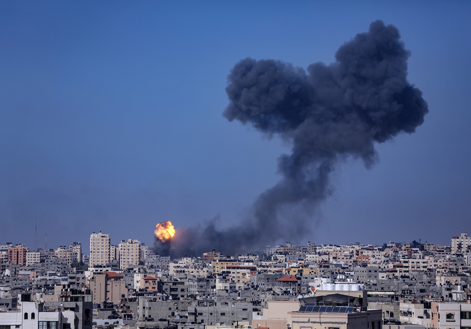 epa09193874 Smoke and flames seen rising up after an Israeli airstrike in the northern Gaza strip, 12 May 2021. At least 40 people were killed in Gaza and five in Israel as tensions have escalated in the region, leading to the heaviest offensive between Israelis and Palestinians in years. The retaliatory airstrike was launched after over 130 rockets were fired by Hamas on Israeli cities amid ongoing clashes.  EPA/HAITHAM IMAD