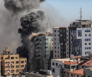 epa09201794 Smoke rises as the building collapses after an Israeli airstrike hits Al-Jalaa tower, which houses apartments and several media outlets, including The Associated Press and Al Jazeera, in Gaza City, 15 May 2021. In response to days of violent confrontations between Israeli security forces and Palestinians in Jerusalem, various Palestinian militants factions in Gaza launched rocket attacks since 10 May that killed at least nine Israelis to date. According to the Palestinian Ministry of Health, at least 139 Palestinians, including 39 children, were killed in the recent retaliatory Israeli airstrikes.  EPA/MOHAMMED SABER