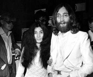 Beatle John Lennon and his wife, Yoko Ono, left, are shown in June 1969 at an airport at an unknown location.  (AP Photo)