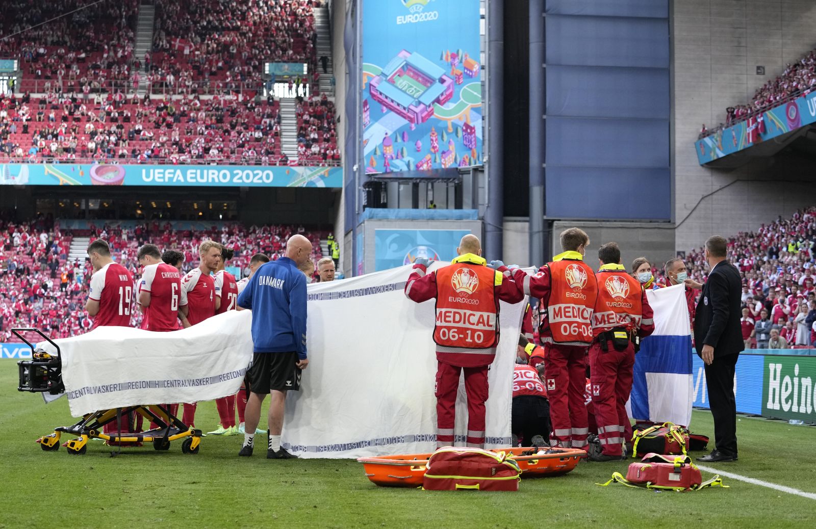 Denmark's Christian Eriksen receives medical attention after collapsing during the Euro 2020 soccer championship group B match between Denmark and Finland at Parken stadium in Copenhagen, Saturday, June 12, 2021. (AP Photo/Martin Meissner, Pool)