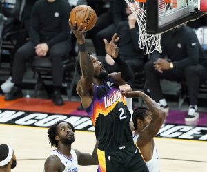 Phoenix Suns center Deandre Ayton, middle, shoots against the Los Angeles Clippers during the first half of Game 2 of the NBA basketball Western Conference Finals, Tuesday, June 22, 2021, in Phoenix. (AP Photo/Matt York)