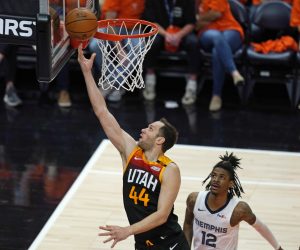 Utah Jazz forward Bojan Bogdanovic (44) lays the ball up as Memphis Grizzlies guard Ja Morant (12) watches during the first half of Game 5 of an NBA basketball first-round playoff series Wednesday, June 2, 2021, in Salt Lake City. (AP Photo/Rick Bowmer)