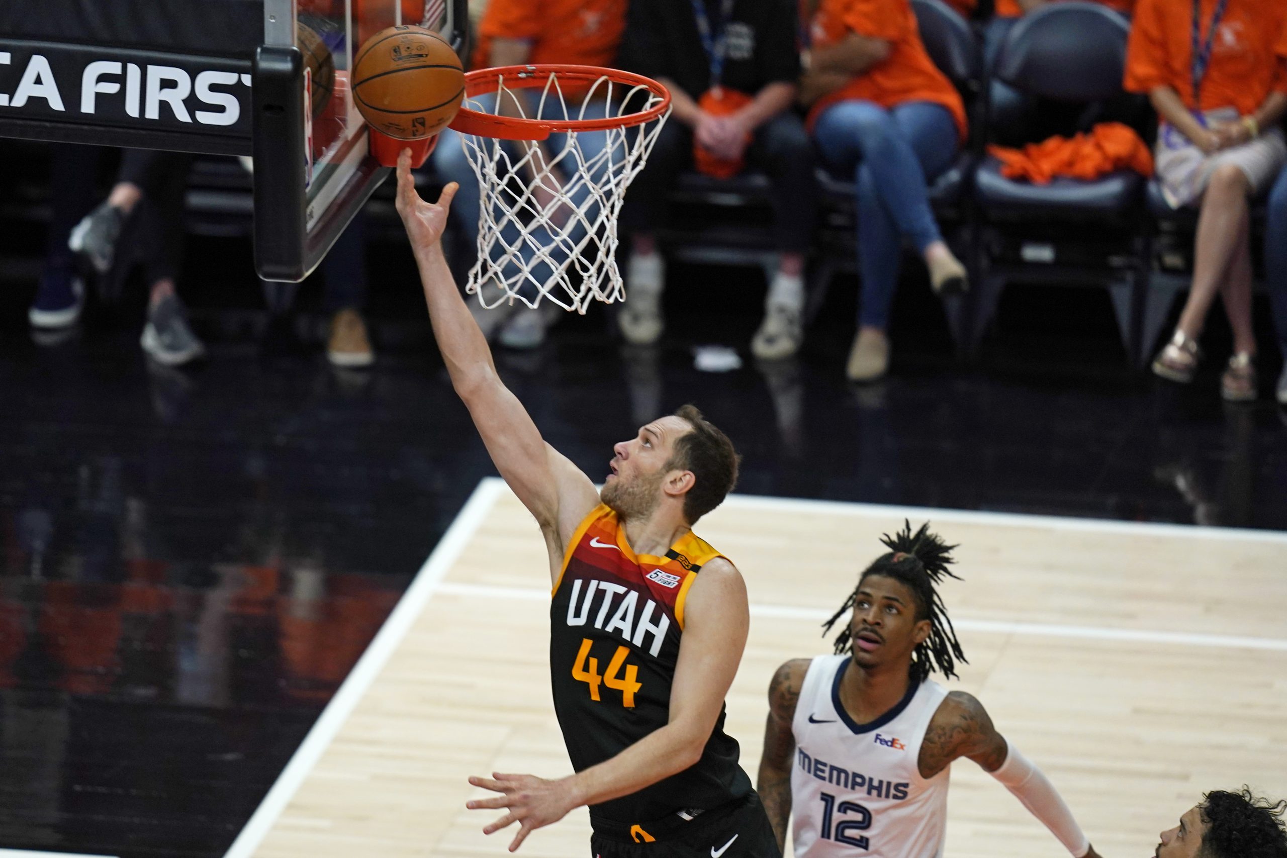 Utah Jazz forward Bojan Bogdanovic (44) lays the ball up as Memphis Grizzlies guard Ja Morant (12) watches during the first half of Game 5 of an NBA basketball first-round playoff series Wednesday, June 2, 2021, in Salt Lake City. (AP Photo/Rick Bowmer)