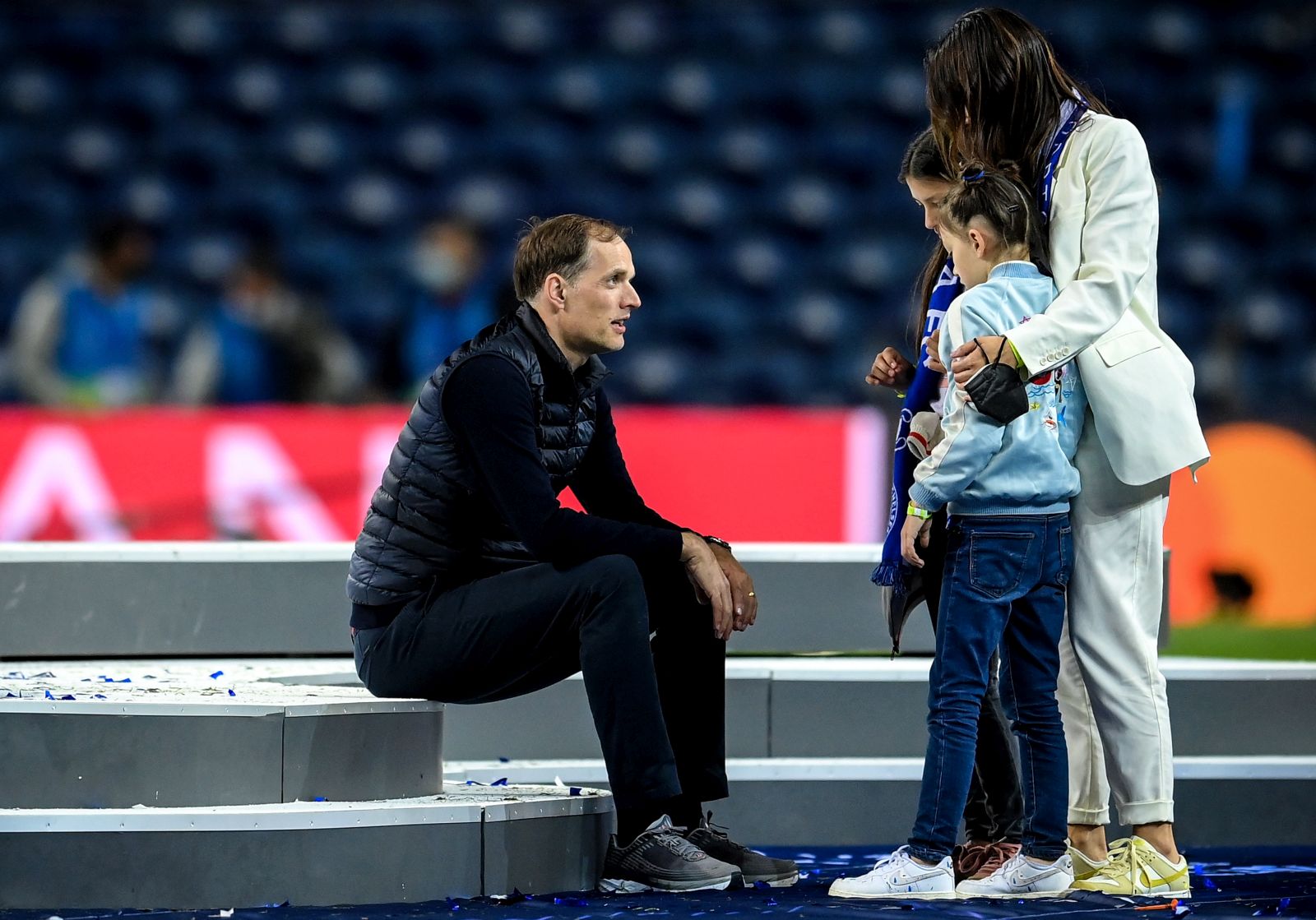 epa09236226 Chelsea manager Thomas Tuchel (L) sits on the podium in front of his family following the UEFA Champions League final between Manchester City and Chelsea FC in Porto, Portugal, 29 May 2021.  EPA/David Ramos / POOL