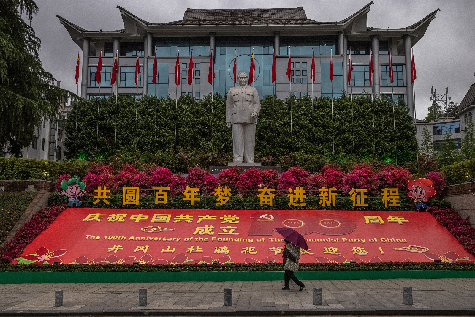 epa09240189 (19/28) A person walks past a statue of Mao Zedong and a banner reminding of the upcoming 100th anniversary of the founding of the Chinese Communist Party (CCP), in Jinggangshan, Jiangxi province, southeastern China, 08 April 2021. The founder of the People’s Republic of China in 1949 still remains a respected figure in China and is dominant in the Communist Party facilities.  EPA/ROMAN PILIPEY  ATTENTION: For the full PHOTO ESSAY text please see Advisory Notice epa09240170