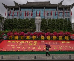 epa09240189 (19/28) A person walks past a statue of Mao Zedong and a banner reminding of the upcoming 100th anniversary of the founding of the Chinese Communist Party (CCP), in Jinggangshan, Jiangxi province, southeastern China, 08 April 2021. The founder of the People’s Republic of China in 1949 still remains a respected figure in China and is dominant in the Communist Party facilities.  EPA/ROMAN PILIPEY  ATTENTION: For the full PHOTO ESSAY text please see Advisory Notice epa09240170