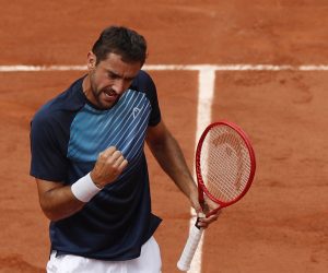 epa09245378 Marin Cilic of Croatia in action against Roger Federer of Switzerland during their second round match at the French Open tennis tournament at Roland Garros in Paris, France, 03 June 2021.  EPA/YOAN VALAT