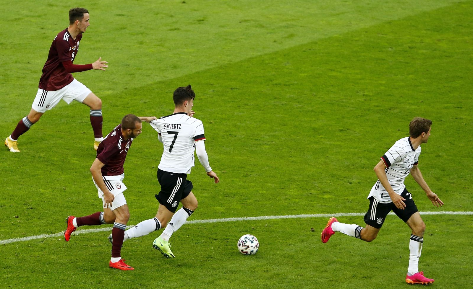 epa09253908 Latvia's Arturs Zjuzins (2-L) in action against Germany's Kai Havertz (C) during the International Friendly soccer match between Germany and Latvia in Duesseldorf, Germany, 07 June 2021.  EPA/THILO SCHMUELGEN / POOL