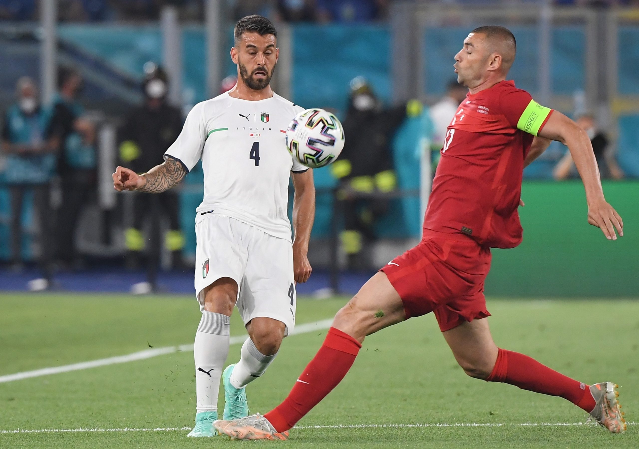 epa09263152 Burak Yilmaz (R) of Turkey in action against Leonardo Spinazzola of Italy during the UEFA EURO 2020 group A preliminary round soccer match between Turkey and Italy at the Olympic Stadium in Rome, Italy, 11 June 2021.  EPA/Alberto Lingria / POOL (RESTRICTIONS: For editorial news reporting purposes only. Images must appear as still images and must not emulate match action video footage. Photographs published in online publications shall have an interval of at least 20 seconds between the posting.)