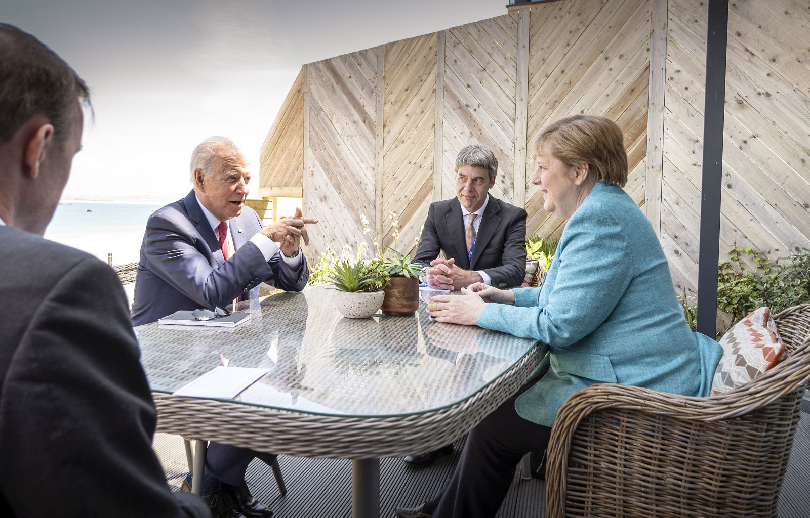 epa09264327 A handout photo made available by the German Government Press Office (BPA) shows German Chancellor Angela Merkel (R) and US President Joe Biden (2-L) at the beginning of their meeting on the sidelines of the G7 summit, in St. Ives, Cornwall, Britain, 12 June 2021. In picture attending the meeting are foreign policy advisor to Chancellor Merkel, Jan Hecker (2-R) and US National Security Advisor Jake Sullivan (L).  EPA/GUIDO BERGMANN/BPA HANDOUT  HANDOUT EDITORIAL USE ONLY/NO SALES