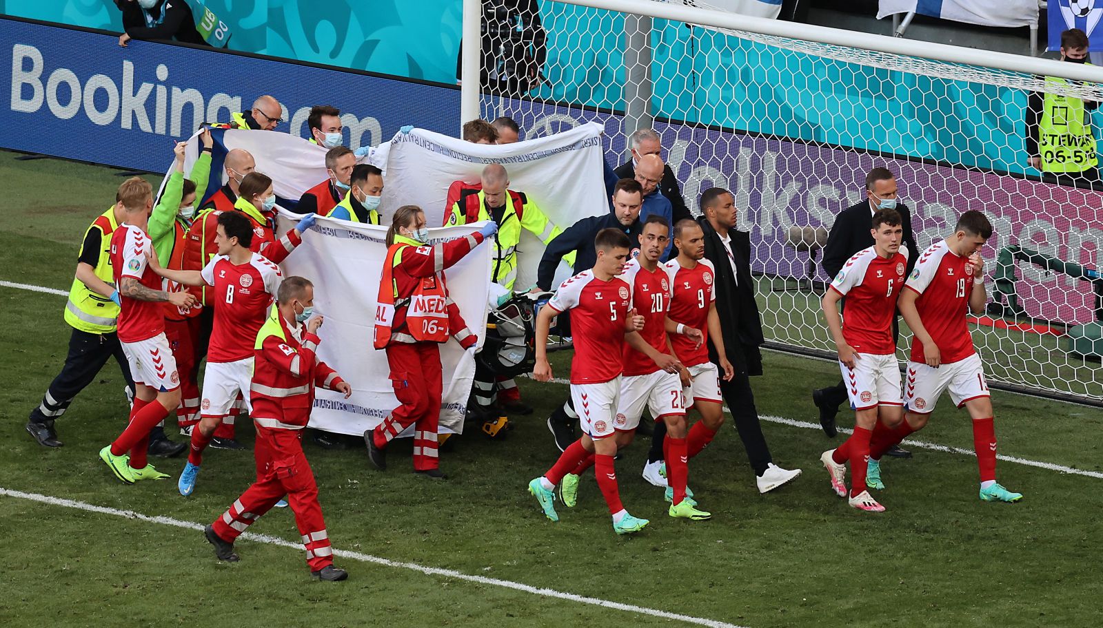 epa09265402 Christian Eriksen of Denmark receives medical attention during the UEFA EURO 2020 group B preliminary round soccer match between Denmark and Finland in Copenhagen, Denmark, 12 June 2021.  EPA/Wolfgang Rattay / POOL (RESTRICTIONS: For editorial news reporting purposes only. Images must appear as still images and must not emulate match action video footage. Photographs published in online publications shall have an interval of at least 20 seconds between the posting.)