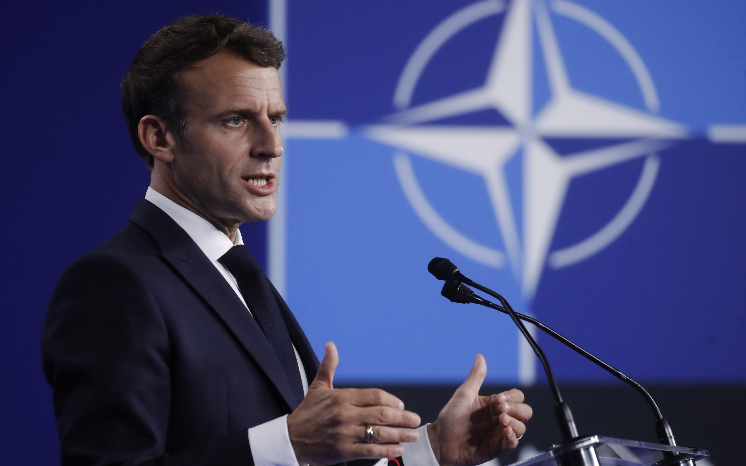 epa09270987 French President Emmanuel Macron gives a press conference during  a NATO summit at the North Atlantic Treaty Organization (NATO) headquarters in Brussels, Belgium, 14 June 2021. The 30-nation alliance hopes to reaffirm its unity and discuss increasingly tense relations with China and Russia, as the organization pulls its troops out after 18 years in Afghanistan.  EPA/OLIVIER HOSLET / POOL