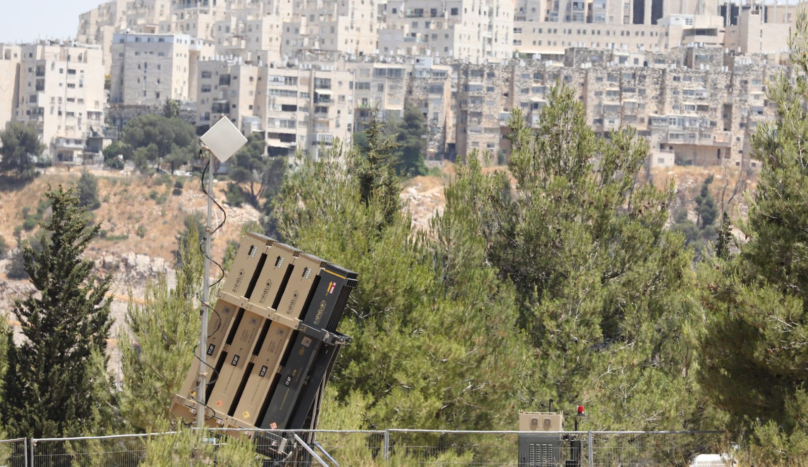 epa09272785 Israeli Iron dome anti missile battery deployed at the entrance to Jerusalem, Israel, 15 June 2021, following threats by the Palestinian militant organization Hamas  if the flag march went through the old city of Jerusalem.  EPA/ABIR SULTAN