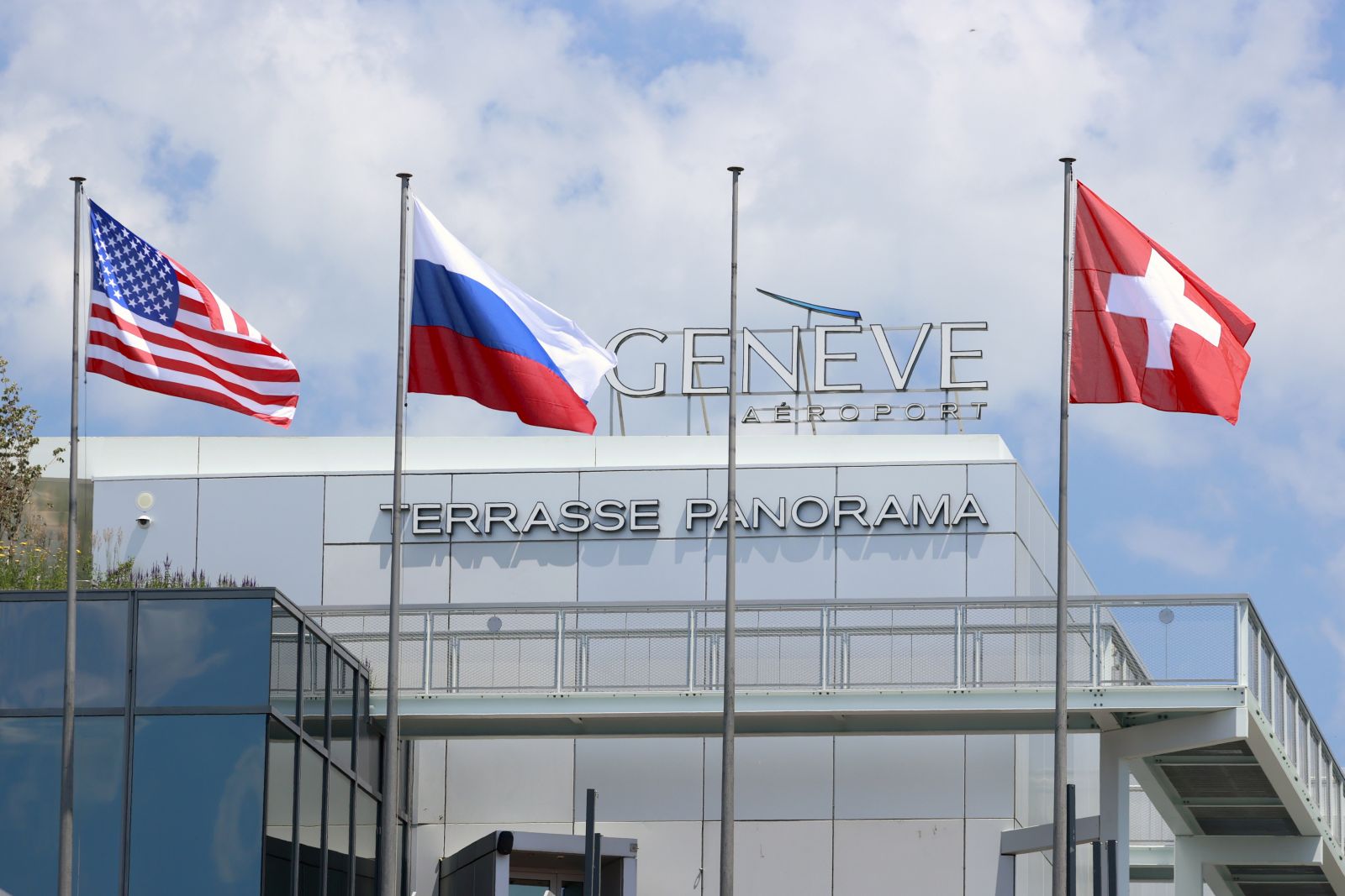 epa09273061 Flags of the US, Russia and Switzerland fly at Cointrin airport ahead of a meeting between US President Joe Biden and his Russian counterpart Vladimir Putin, in Geneva, Switzerland, 15 June 2021. The meeting between US President Joe Biden and Russian President Vladimir Putin is scheduled in Geneva for 16 June 2021.  EPA/DENIS BALIBOUSE / POOL