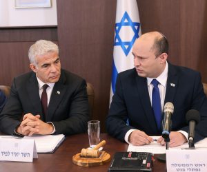 epa09287678 Israeli Prime Minister Naftali Bennett (R) flanked by alternate prime minister and Foreign Minister Yair Lapid, chairs the first weekly cabinet meeting of his new government in Jerusalem, 20 June 2021.  EPA/EMMANUEL DUNAND / POOL