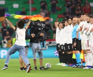 epa09296677 A pitch invader with a rainbow colours flag before the UEFA EURO 2020 group F preliminary round soccer match between Germany and Hungary in Munich, Germany, 23 June 2021.  EPA/Kai Pfaffenbach / POOL (RESTRICTIONS: For editorial news reporting purposes only. Images must appear as still images and must not emulate match action video footage. Photographs published in online publications shall have an interval of at least 20 seconds between the posting.)