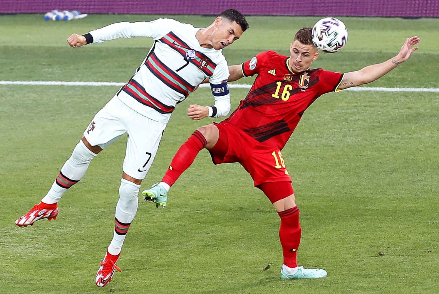 epa09306299 Thorgan Hazard (R) of Belgium in action against Cristiano Ronaldo (L) of Portugal during the UEFA EURO 2020 round of 16 soccer match between Belgium and Portugal in Seville, Spain, 27 June 2021.  EPA/Jose Manuel Vidal / POOL (RESTRICTIONS: For editorial news reporting purposes only. Images must appear as still images and must not emulate match action video footage. Photographs published in online publications shall have an interval of at least 20 seconds between the posting.)