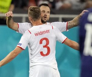 epa09309360 Haris Seferovic (R) of Switzerland celebrates with team-mate Silvan Widmer after scoring the 0-1 goal during the UEFA EURO 2020 round of 16 soccer match between France and Switzerland in Bucharest, Romania, 28 June 2021.  EPA/Vadim Ghirda / POOL (RESTRICTIONS: For editorial news reporting purposes only. Images must appear as still images and must not emulate match action video footage. Photographs published in online publications shall have an interval of at least 20 seconds between the posting.)