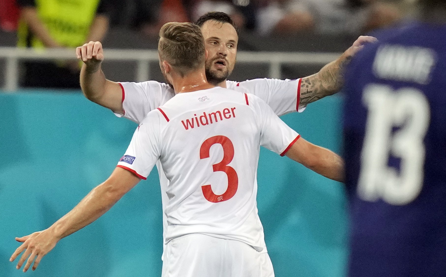 epa09309360 Haris Seferovic (R) of Switzerland celebrates with team-mate Silvan Widmer after scoring the 0-1 goal during the UEFA EURO 2020 round of 16 soccer match between France and Switzerland in Bucharest, Romania, 28 June 2021.  EPA/Vadim Ghirda / POOL (RESTRICTIONS: For editorial news reporting purposes only. Images must appear as still images and must not emulate match action video footage. Photographs published in online publications shall have an interval of at least 20 seconds between the posting.)