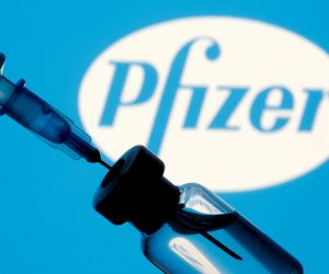 FILE PHOTO: Vial and syringe are seen in front of displayed Pfizer logo FILE PHOTO: A vial and syringe are seen in front of a displayed Pfizer logo in this illustration taken January 11, 2021. REUTERS/Dado Ruvic/Illustration/File Photo Dado Ruvic