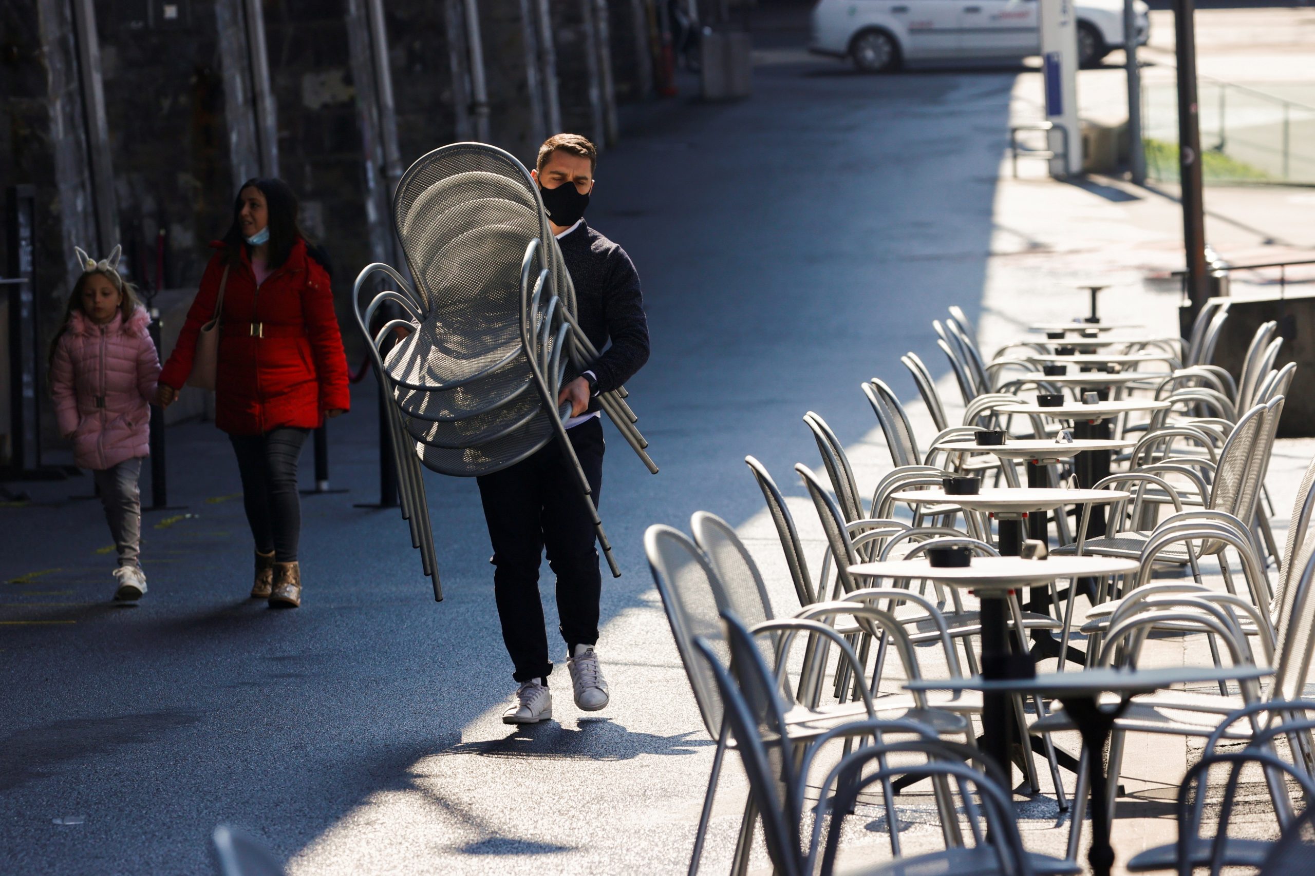 FILE PHOTO: A worker carries chairs at Les Arches bar in the city centre, as coronavirus disease (COVID-19) lockdown restrictions ease, in Lausanne, Switzerland April 19, 2021 FILE PHOTO: A worker carries chairs at Les Arches bar in the city centre, as coronavirus disease (COVID-19) lockdown restrictions ease, in Lausanne, Switzerland April 19, 2021. REUTERS/Denis Balibouse/File Photo DENIS BALIBOUSE