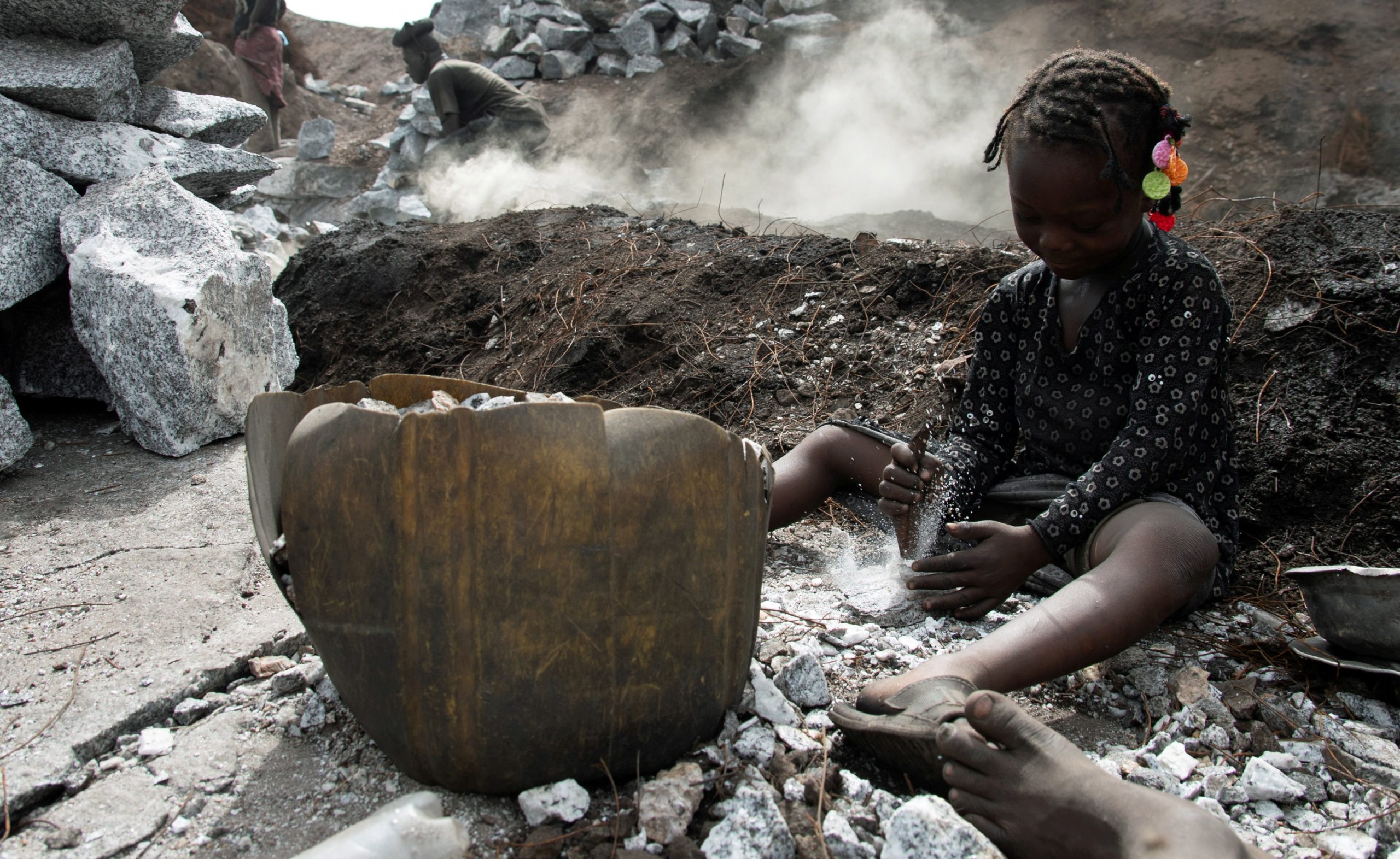 FILE PHOTO: Outbreak of the coronavirus disease (COVID-19), in Ouagadougou FILE PHOTO: Oumeima Ouedraogo, 7, crashes stones next to burning tires at the Pissy informal granite quarry since schools closed amid the outbreak of the  coronavirus disease (COVID-19), in Ouagadougou, Burkina Faso June 12, 2020. Picture taken June 12,  2020. REUTERS / Anne Mimault/File Photo Anne Mimault